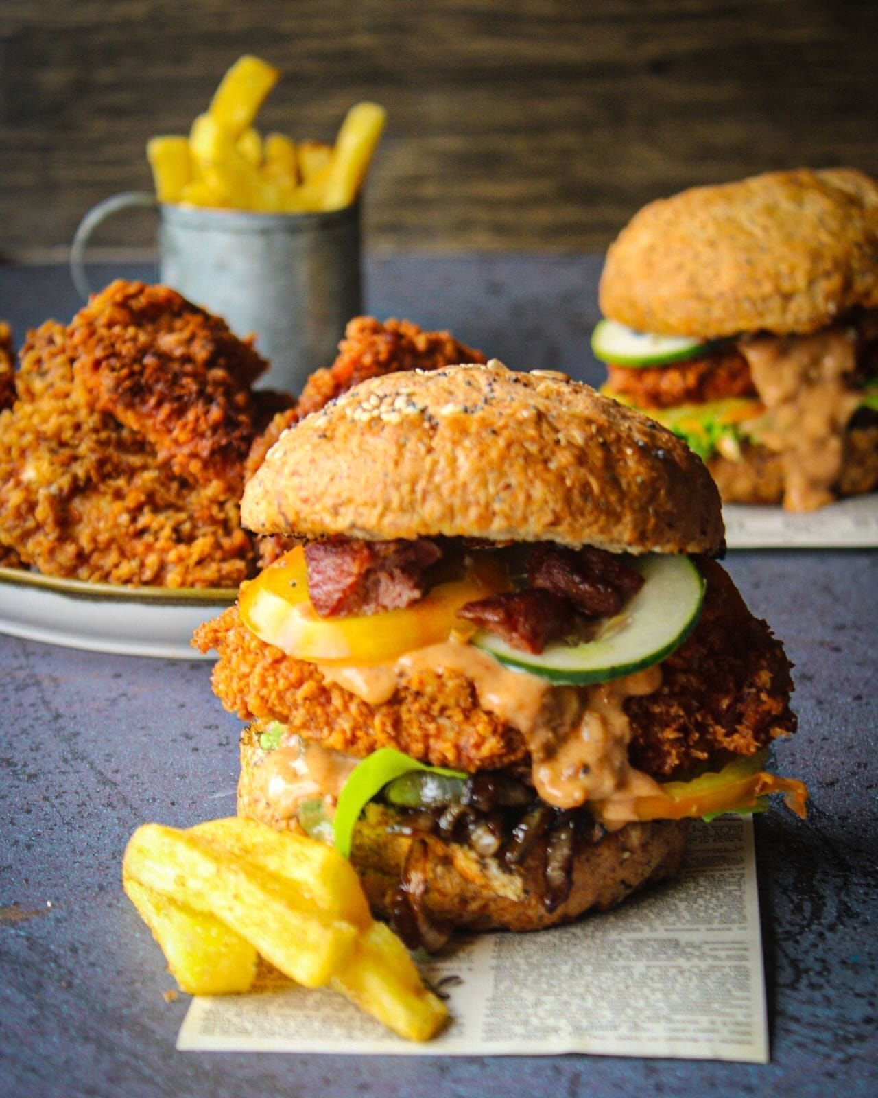 Crispy fried chicken burgers with fries styled for Country Choice Chicken