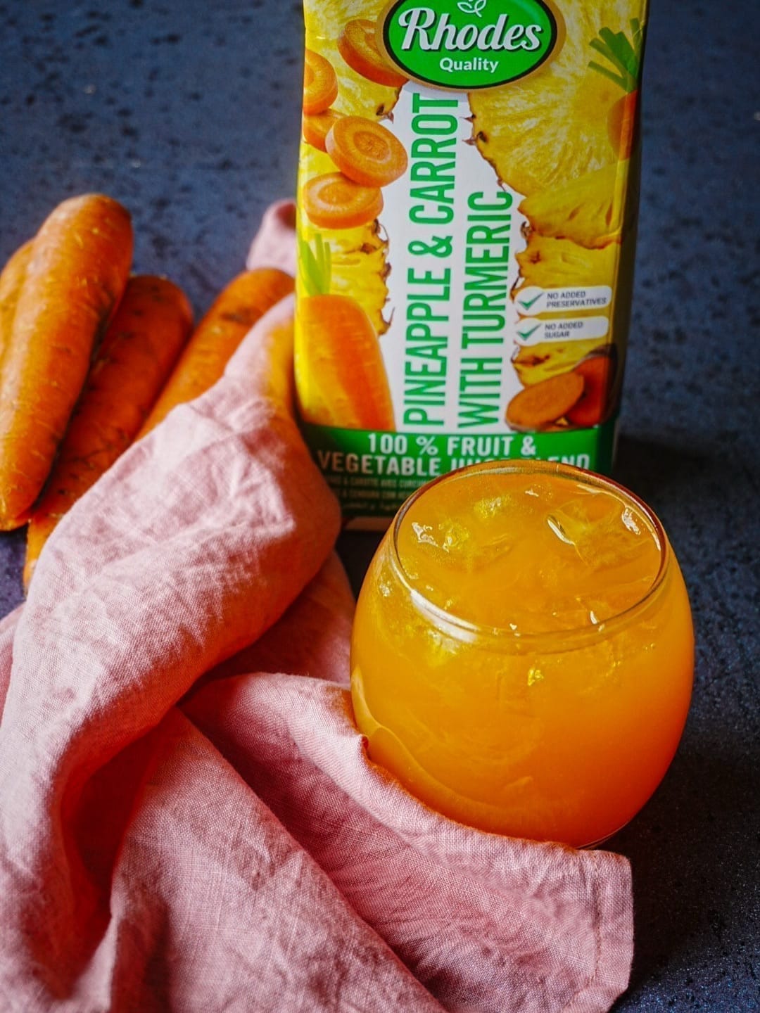 Rhodes Quality pineapple and carrot juice styled with fresh carrots for Rhodes Food Group