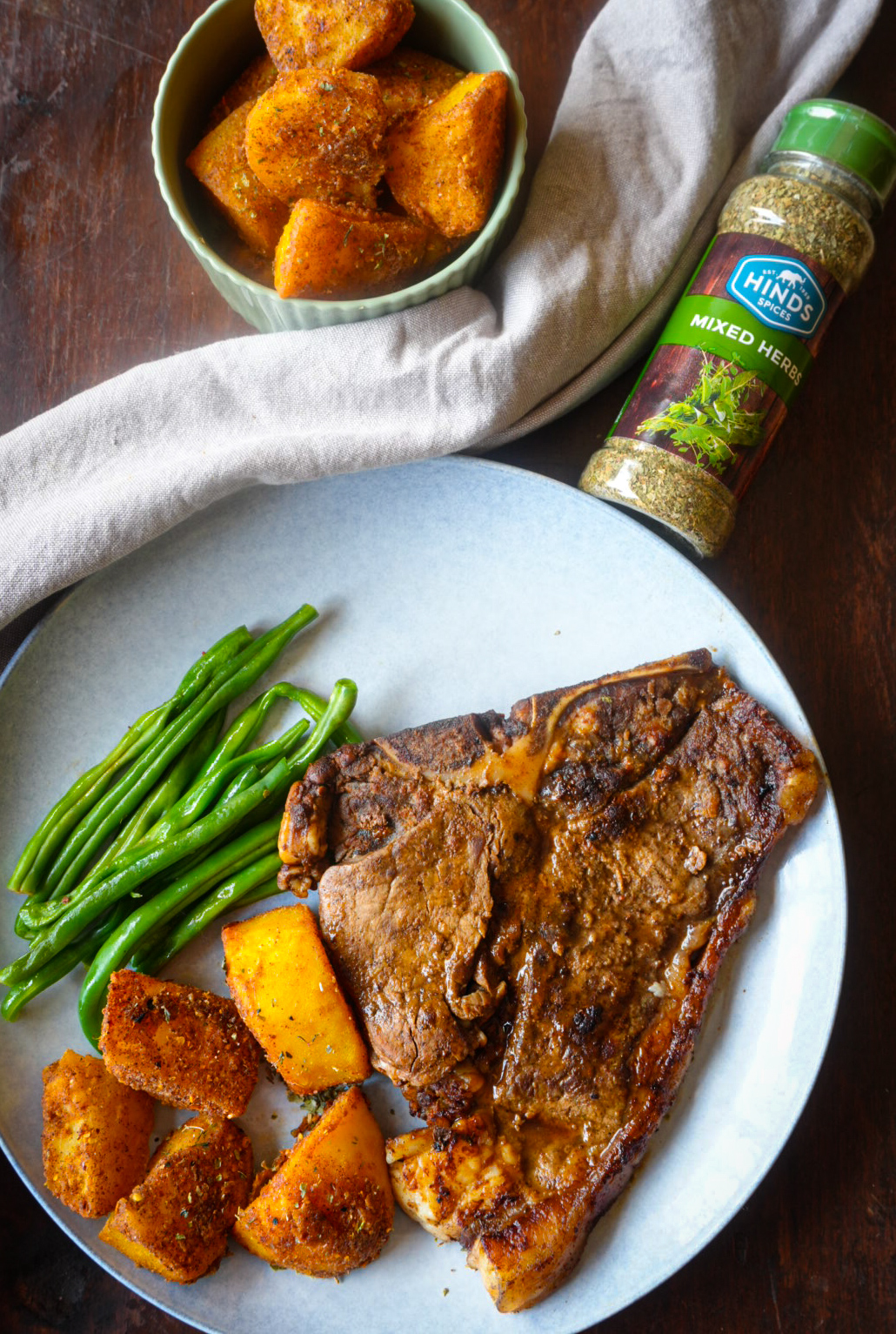 Overhead shot of Rhodes Quality seasoned roasted potatoes and steak